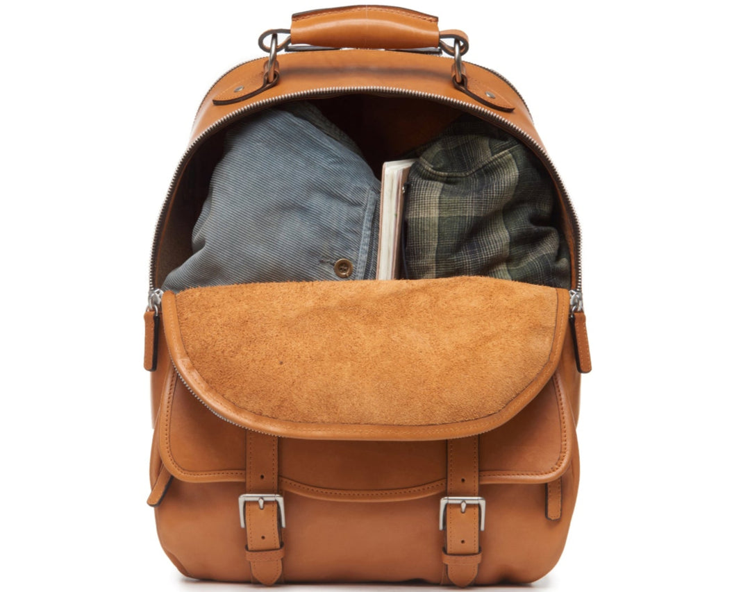 Tan Handcrafted with full grain American leather Padded backpack shoulder straps Roomy interior and front pocket Keychain attachment Interior organizer panel Fits up to a 15" laptop  Strap designed for easy carry on telescoping luggage handles Handcrafted with care in our own factory Natural leather lining Dimensions: 17" x 7" x 12" #color_tan