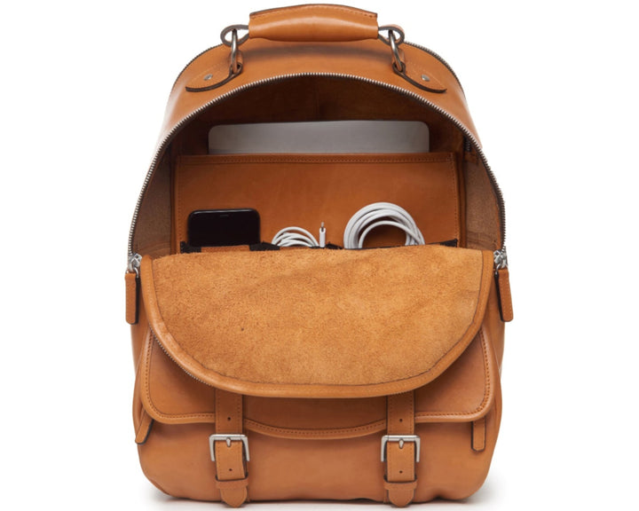 Tan Handcrafted with full grain American leather Padded backpack shoulder straps Roomy interior and front pocket Keychain attachment Interior organizer panel Fits up to a 15" laptop  Strap designed for easy carry on telescoping luggage handles Handcrafted with care in our own factory Natural leather lining Dimensions: 17" x 7" x 12" #color_tan