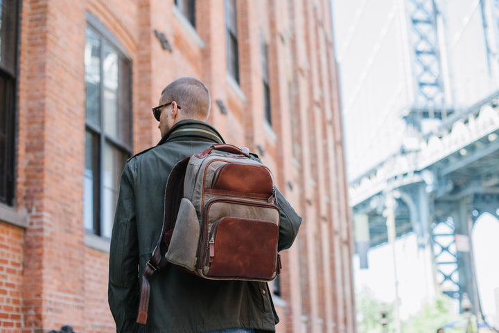 Olive Waxed Canvas and Leather Backpack The Mason is a waxed canvas and leather backpack designed to accommodate a 15" laptop. Featuring numerous organizational pockets, including a water resistant side pocket designed for water bottles, and an interior iPad pocket, the Mason is an ideal solution for work or leisure. #color_olive #color_olive