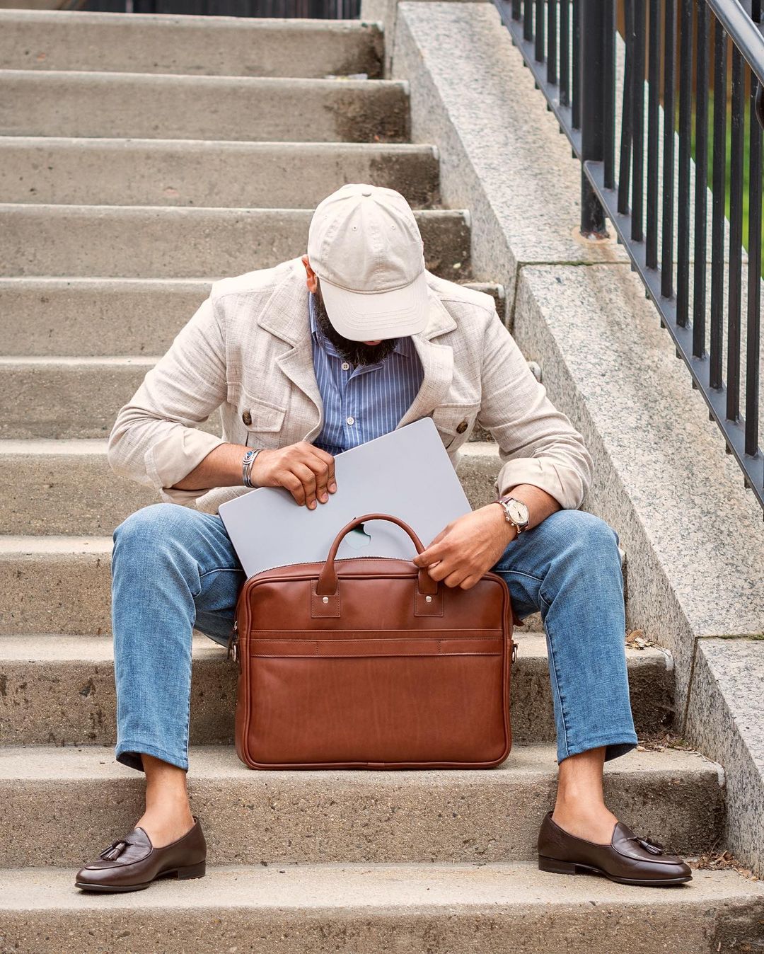 The Dylan leather briefcase features a removable, adjustable shoulder strap and built-in computer sleeve. It is designed with a secure top zipper, and can safely accommodate most 15" laptops #color_brown